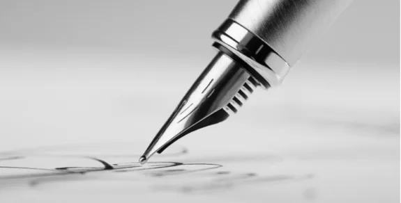 A pen signing a document